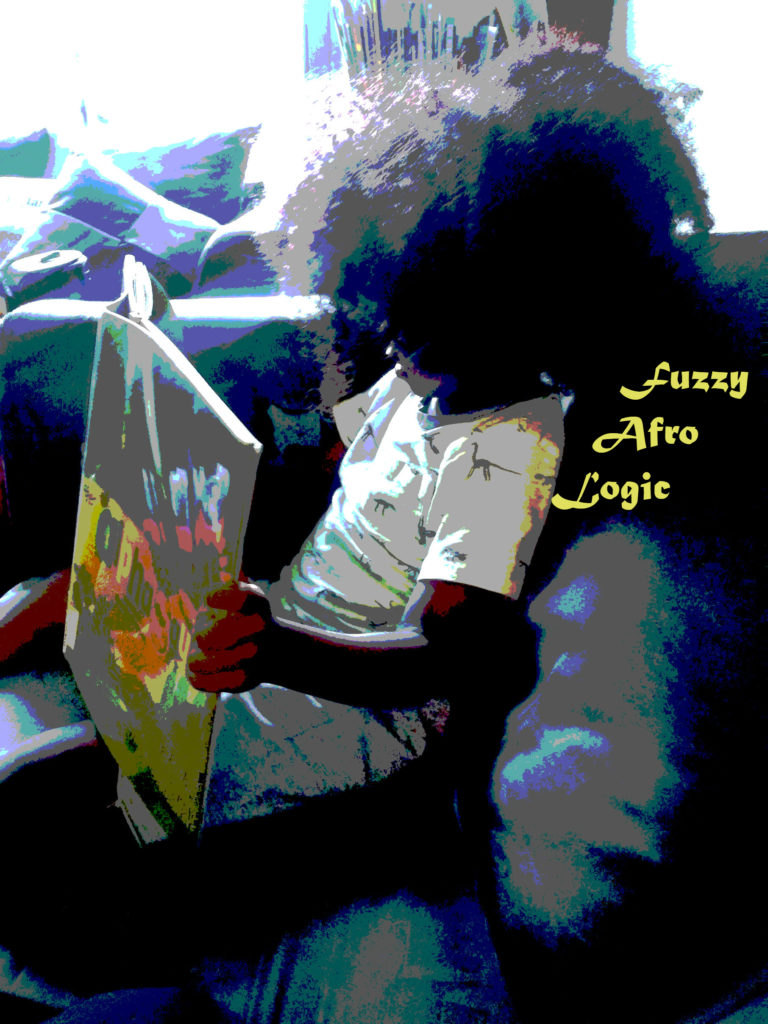 A little boy with a huge afro is looking down at a book. The words fuzzy afro logic are in yellow behind him.